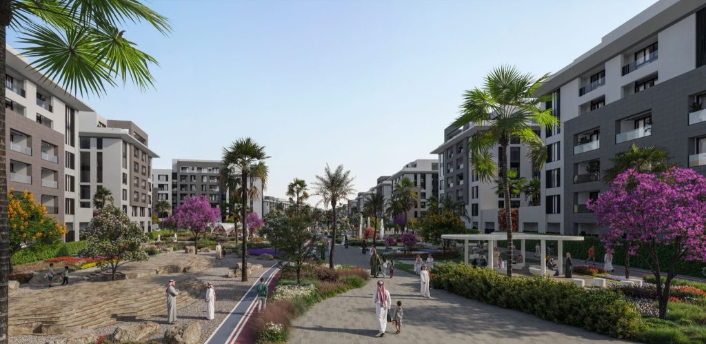 Al Alyaa, Knowledge Economic City Madinah — landscaped boulevard with palm trees between new apartment buildings